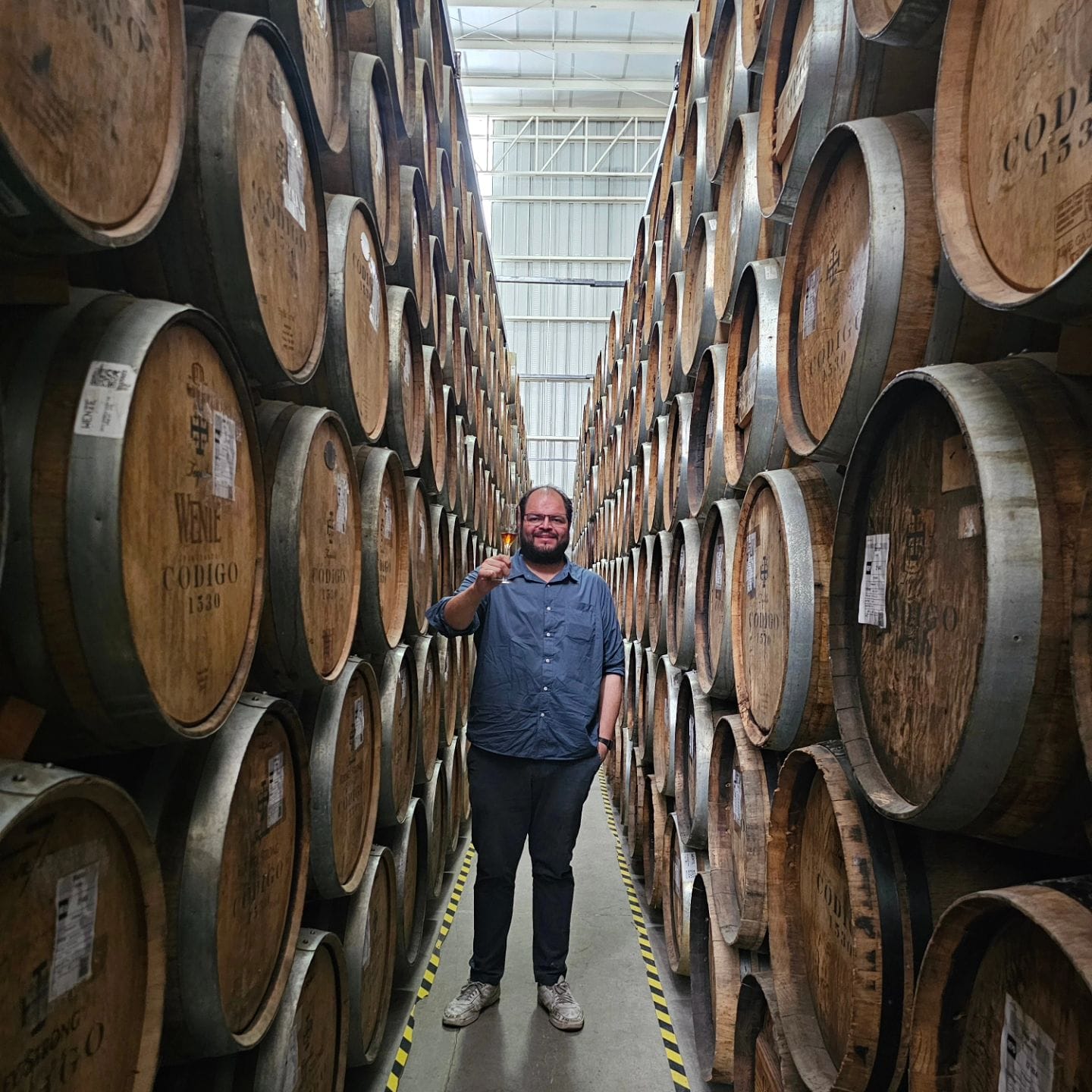 Oliver Castilla in warehouse with barrels of tequila