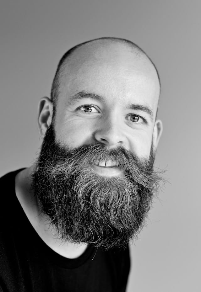 Smiling man with a full beard