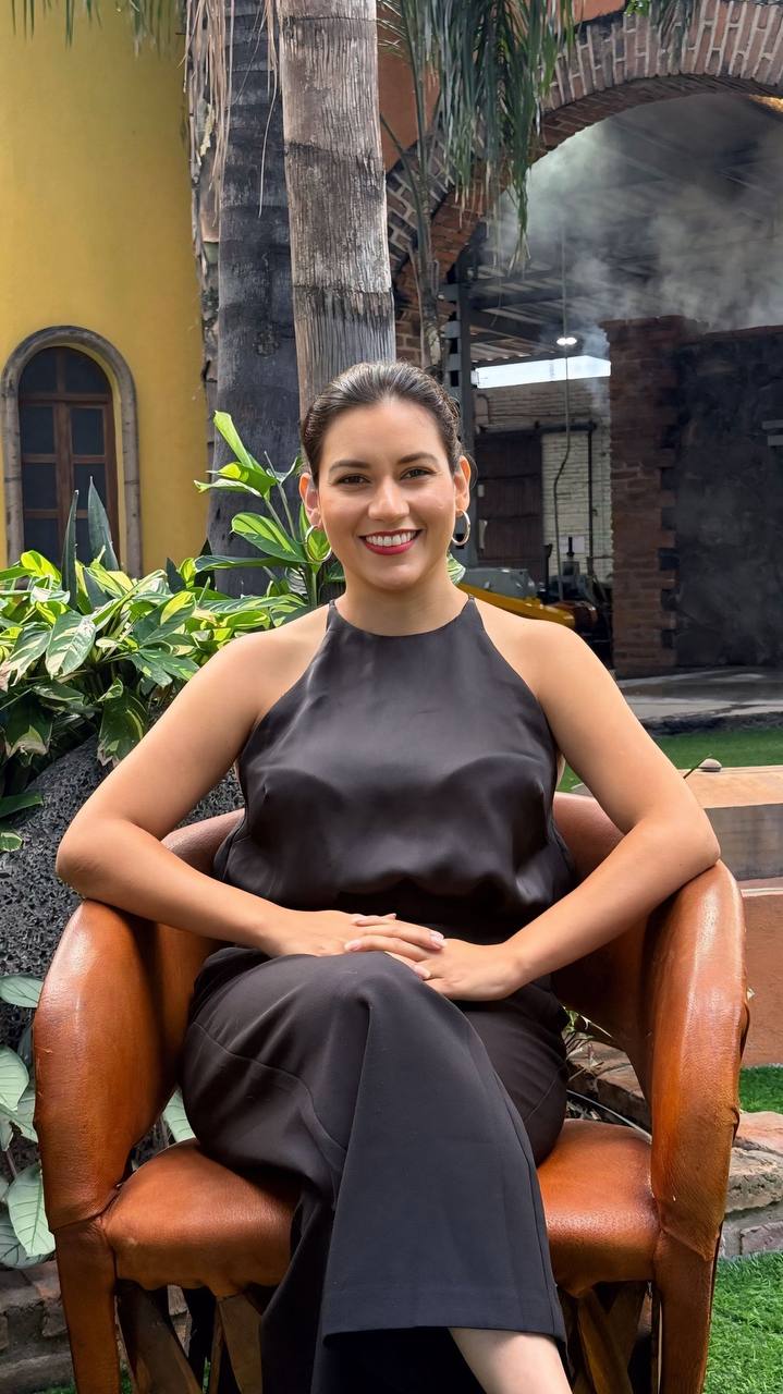 Smiling person sitting outdoors in a chair