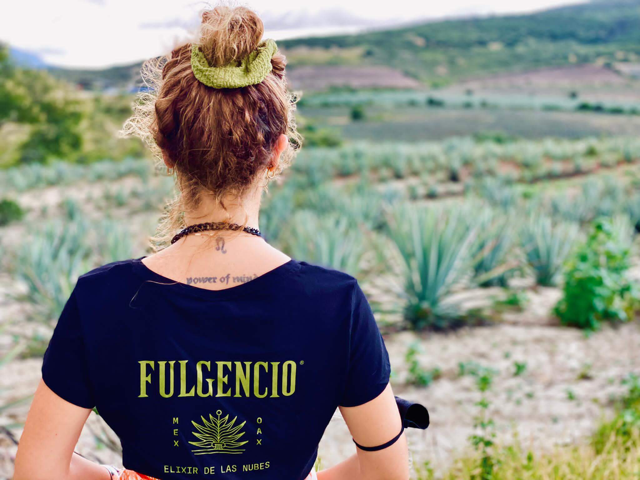 Woman overlooking agave field in rural landscape
