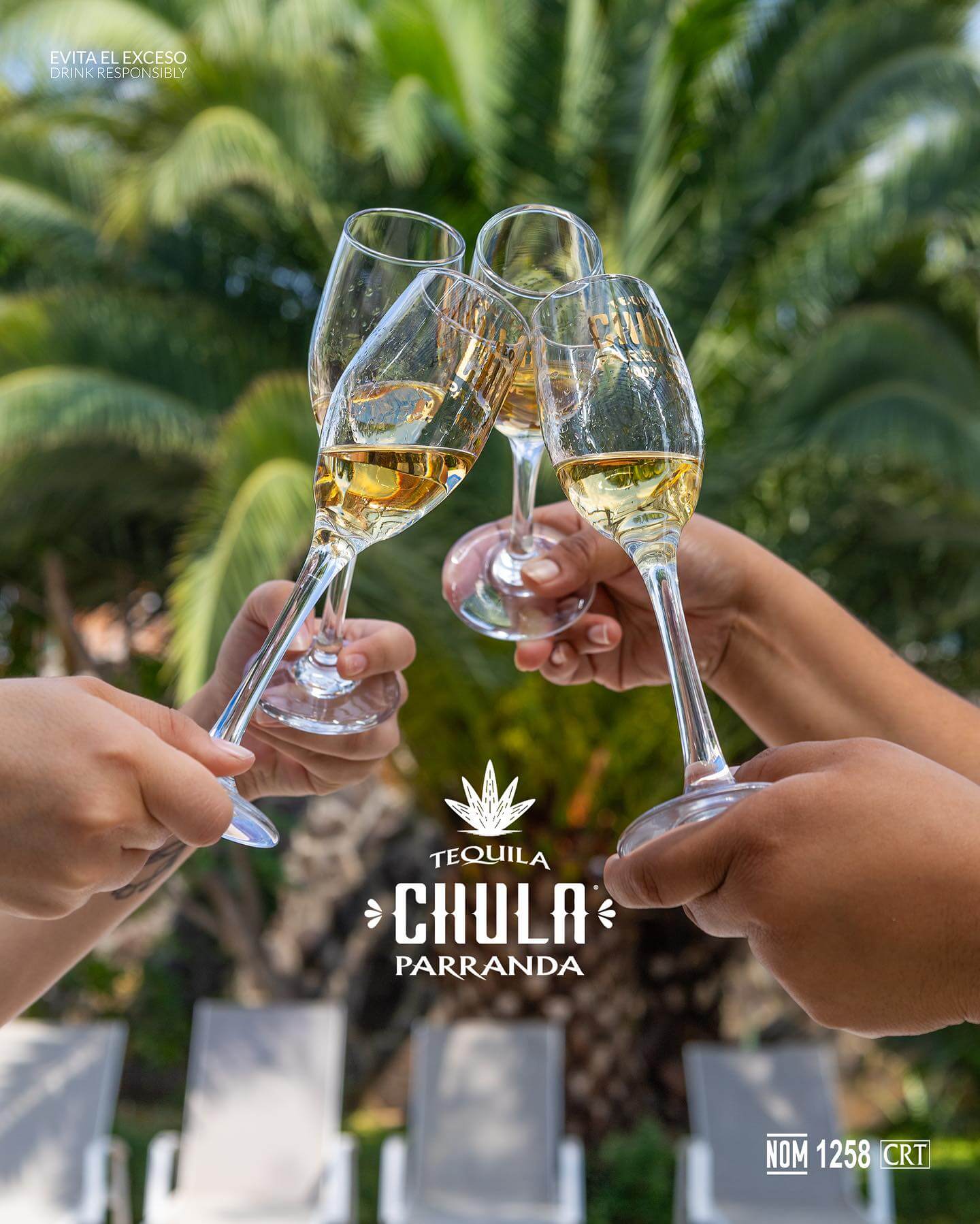 Friends toasting tequila glasses outdoors with palm trees